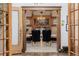 Elegant dining room featuring a chandelier and built-in hutch with a view through the doorways at 1521 Pontiac St, Denver, CO 80220