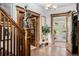 Elegant foyer featuring beautiful hardwood floors, staircase, and decorative statue at 1521 Pontiac St, Denver, CO 80220