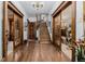 Spacious foyer showcasing hardwood floors, staircase, and elegant wood framed doorways at 1521 Pontiac St, Denver, CO 80220