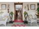 Charming front porch with decorative chairs and views into the home at 1521 Pontiac St, Denver, CO 80220