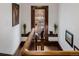 Hallway featuring wooden railing, decor, and a view of the outdoor deck at 1521 Pontiac St, Denver, CO 80220