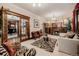 Cozy living room featuring a fireplace, elegant furnishings, and a view of the dining room at 1521 Pontiac St, Denver, CO 80220