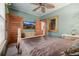 Angled view of the main bedroom displaying a TV and an ornate framed mirror at 1521 Pontiac St, Denver, CO 80220