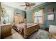 Spacious main bedroom featuring a unique ceiling fan and hardwood poster bed frame at 1521 Pontiac St, Denver, CO 80220