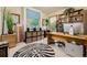Bright office space with a large desk, shelving, zebra rug, and natural lighting at 1521 Pontiac St, Denver, CO 80220
