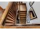 Wooden staircase with wood railing and decorations on the wall at 1521 Pontiac St, Denver, CO 80220
