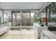 Bright sun room with tiled floors and lots of natural light overlooking the back yard at 1521 Pontiac St, Denver, CO 80220