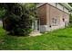 Basement walkout with a concrete patio and double glass doors surrounded by green landscaping at 1312 Sandstone Ct, Boulder, CO 80305