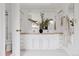 Bathroom featuring a double vanity with a large mirror, decorative plants, and white cabinets at 1312 Sandstone Ct, Boulder, CO 80305