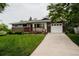 Charming single-story home with brick accents, attached garage, and well-maintained lawn at 1312 Sandstone Ct, Boulder, CO 80305