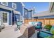 Back deck featuring a fire pit, outdoor seating, and privacy fencing at 8156 E 35Th Ave, Denver, CO 80238