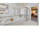 Bright bathroom with a soaking tub and shower featuring white tile, perfect for unwinding at 8156 E 35Th Ave, Denver, CO 80238