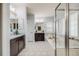 This bright bathroom features a soaking tub, walk-in shower, double vanity, and modern fixtures at 8156 E 35Th Ave, Denver, CO 80238