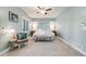 This serene bedroom features soft blue walls, plush carpeting, and ample natural light at 8156 E 35Th Ave, Denver, CO 80238