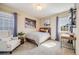 Cozy bedroom with a comfortable bed, industrial-style shelving, and soft natural light, perfect for relaxation at 8156 E 35Th Ave, Denver, CO 80238