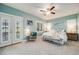 This serene bedroom features soft blue walls, plush carpeting, and ample natural light at 8156 E 35Th Ave, Denver, CO 80238