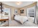 Relaxing bedroom with soft light and decor, featuring large windows and a comfy bed at 8156 E 35Th Ave, Denver, CO 80238