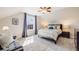 Bright bedroom with a large window, carpet floors, a cozy bed, and neutral-colored walls at 8156 E 35Th Ave, Denver, CO 80238
