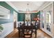 Elegant dining room with stylish lighting, wainscoting, and hardwood floors at 8156 E 35Th Ave, Denver, CO 80238