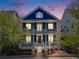 Two-story home showcasing a double porch and manicured front yard at dusk at 8156 E 35Th Ave, Denver, CO 80238