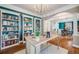 Bright office featuring custom built-ins, a stylish desk, and hardwood floors at 8156 E 35Th Ave, Denver, CO 80238