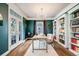 Elegant home office with built-in bookshelves, a stylish desk, and natural light at 8156 E 35Th Ave, Denver, CO 80238