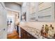 This modern kitchen features granite countertops, white cabinets, and stainless steel appliances at 8156 E 35Th Ave, Denver, CO 80238