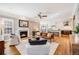 Open-concept living room with fireplace, flowing into a bright and modern kitchen at 8156 E 35Th Ave, Denver, CO 80238