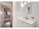 Bright bathroom featuring a modern vanity, mirror, and a glimpse into an adjacent bedroom at 1612 Cottonwood Dr # 2W, Louisville, CO 80027