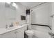 Bathroom featuring a sink, toilet and tub with white tile and black trim at 1612 Cottonwood Dr # 2W, Louisville, CO 80027