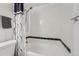 Bathroom featuring a shower and tub with white tile and black trim at 1612 Cottonwood Dr # 2W, Louisville, CO 80027