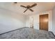 Bedroom featuring carpeted floors, natural light, wood closet doors and a ceiling fan at 1612 Cottonwood Dr # 2W, Louisville, CO 80027