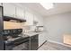 Kitchen with black appliances and butcher block island at 1612 Cottonwood Dr # 2W, Louisville, CO 80027