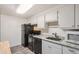 Kitchen with granite countertops and black appliances at 1612 Cottonwood Dr # 2W, Louisville, CO 80027