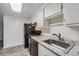 Kitchen featuring white cabinets, gray granite countertops, stainless steel sink and black appliances at 1612 Cottonwood Dr # 2W, Louisville, CO 80027