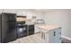 Kitchen with black appliances and butcher block island at 1612 Cottonwood Dr # 2W, Louisville, CO 80027