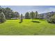 Expansive green lawn with mature trees and building view at 1612 Cottonwood Dr # 2W, Louisville, CO 80027