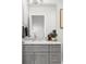 Elegant bathroom with gray cabinets, a spacious vanity, and modern fixtures for a luxurious feel at 1457 Yates St, Denver, CO 80204