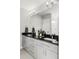 Modern bathroom featuring a double vanity with black countertops and stylish lighting fixtures at 1457 Yates St, Denver, CO 80204