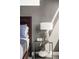 Cozy bedroom featuring a stylish nightstand with a lamp, decorative vase, and a large bed at 1457 Yates St, Denver, CO 80204