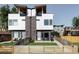 Modern two-story home with a well-manicured lawn, rooftop decks, and a charming fenced-in yard at 1457 Yates St, Denver, CO 80204