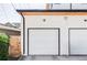 Spacious two car garage with white door and wood fence at 1457 Yates St, Denver, CO 80204