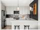Modern kitchen with stainless steel appliances, sleek countertops, and stylish bar stool seating at 1457 Yates St, Denver, CO 80204