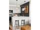 Bright, modern kitchen featuring stainless steel appliances, bar stool seating, and stylish pendant lights at 1457 Yates St, Denver, CO 80204