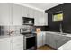 Contemporary kitchen with stainless steel appliances, modern cabinets, and sleek countertops at 1457 Yates St, Denver, CO 80204