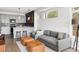 Modern living room with a spacious sofa, stylish lighting, and view of the open kitchen at 1457 Yates St, Denver, CO 80204