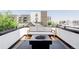 Enjoy city views from this outdoor deck featuring comfortable seating and a modern fire pit at 1457 Yates St, Denver, CO 80204