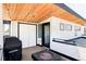 Cozy outdoor patio with a fire pit and tongue and groove plank ceiling with lights at 1457 Yates St, Denver, CO 80204
