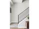 Modern staircase with gray carpet, black metal railings, white walls, and stylish decor at 1457 Yates St, Denver, CO 80204