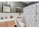 Clean bathroom with floral shower curtain and vanity at 12832 Mayfair Way # F, Englewood, CO 80112